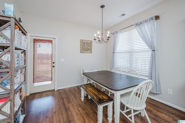 dining area featuring a chandelier and dark hardwood / wood-style flooring