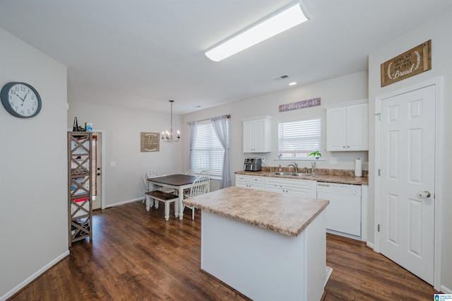 kitchen with white cabinets, sink, decorative light fixtures, dishwasher, and a center island