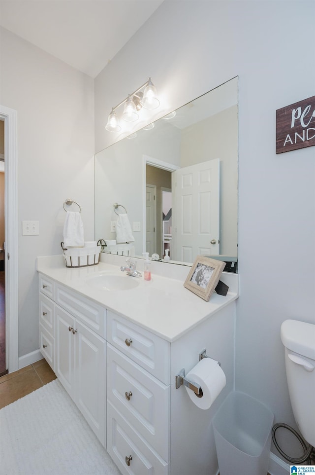 bathroom featuring tile patterned floors, vanity, and toilet