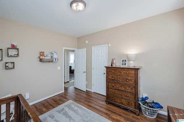 bedroom with dark hardwood / wood-style floors