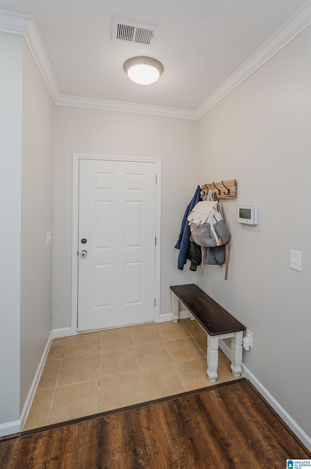 interior space with tile patterned floors and ornamental molding