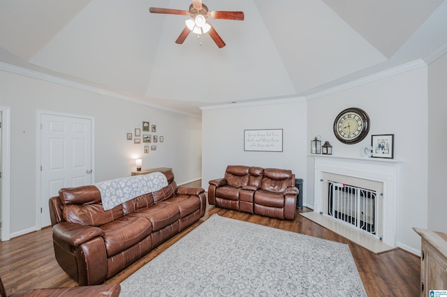 living room with a raised ceiling, crown molding, vaulted ceiling, ceiling fan, and dark hardwood / wood-style flooring