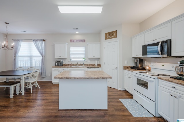 kitchen with white cabinetry, dark hardwood / wood-style flooring, decorative light fixtures, electric stove, and a kitchen island