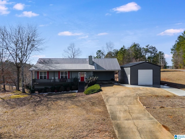 ranch-style house featuring a porch, a garage, and an outbuilding