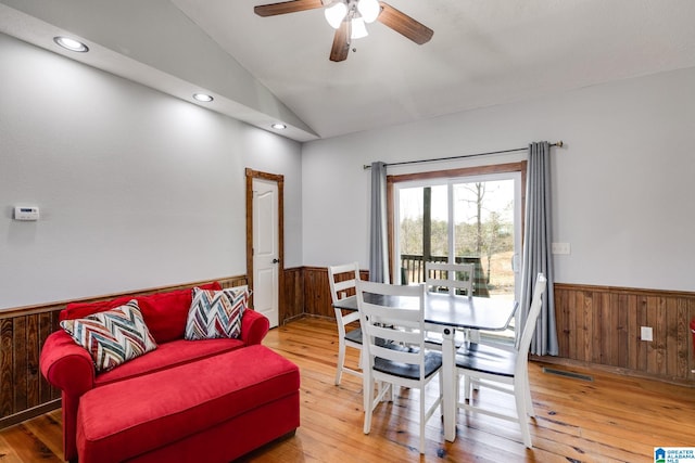 dining area with ceiling fan, hardwood / wood-style floors, and vaulted ceiling