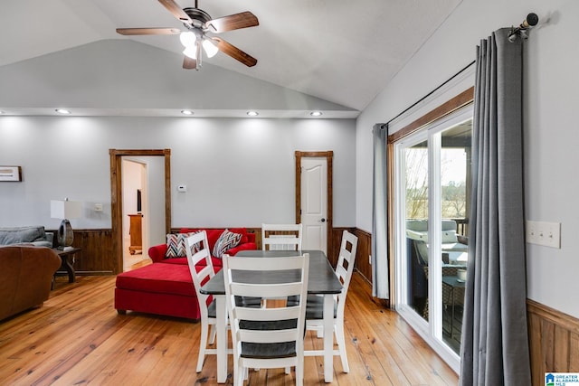 dining space with light hardwood / wood-style flooring, vaulted ceiling, and ceiling fan