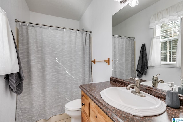 bathroom with tile patterned flooring, vanity, and toilet