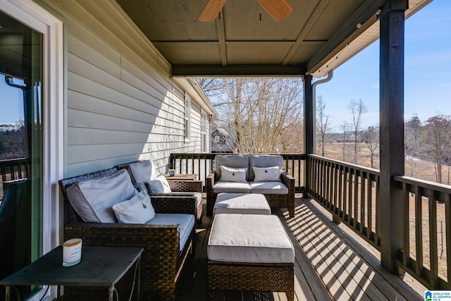 wooden terrace with ceiling fan and an outdoor living space