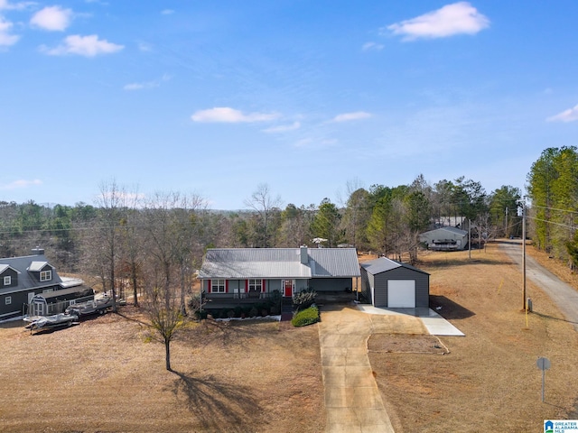 view of front of house featuring an outbuilding, a porch, and a garage