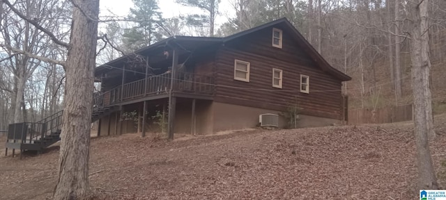 view of side of home featuring a wooden deck