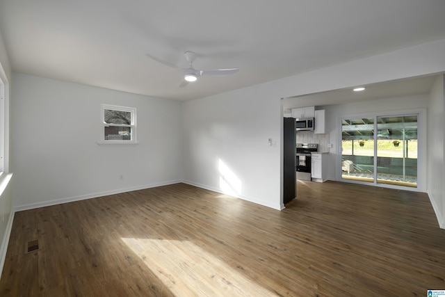 spare room with ceiling fan and dark wood-type flooring