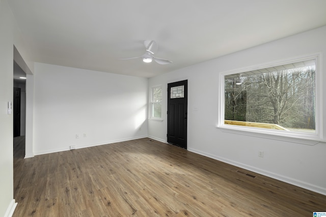 interior space with ceiling fan and wood-type flooring