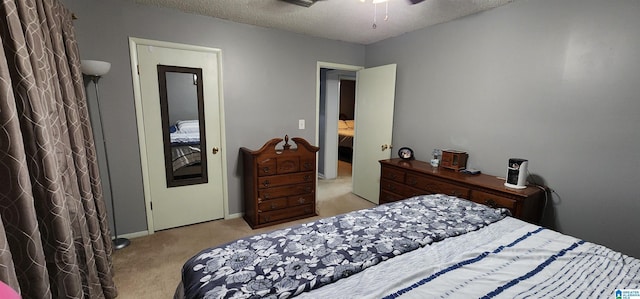 bedroom with a textured ceiling and light carpet