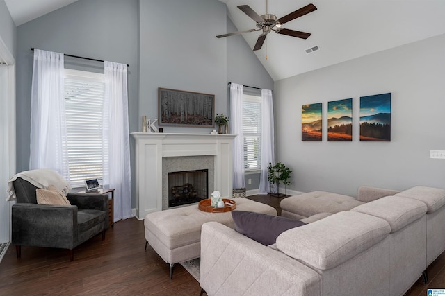 living room with dark hardwood / wood-style floors, ceiling fan, plenty of natural light, and high vaulted ceiling