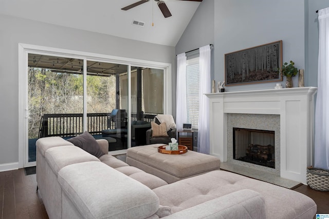 living room with vaulted ceiling, ceiling fan, and dark wood-type flooring