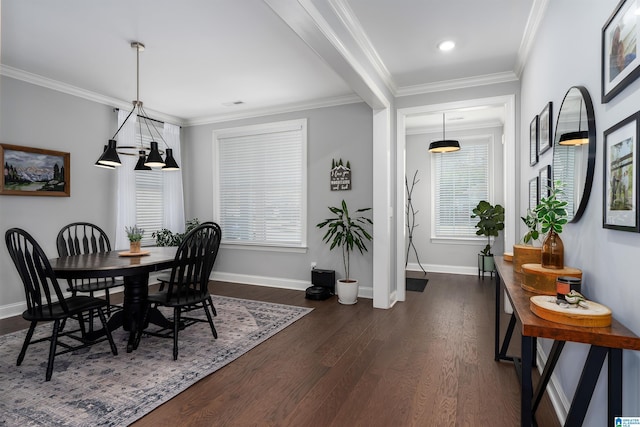 dining room featuring dark hardwood / wood-style flooring, an inviting chandelier, and crown molding