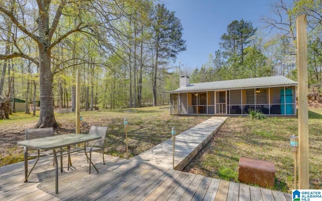 exterior space featuring a lawn and a sunroom