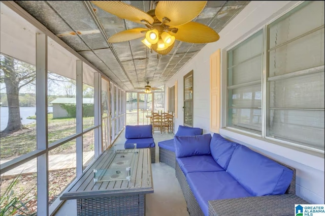 unfurnished sunroom with a water view and ceiling fan