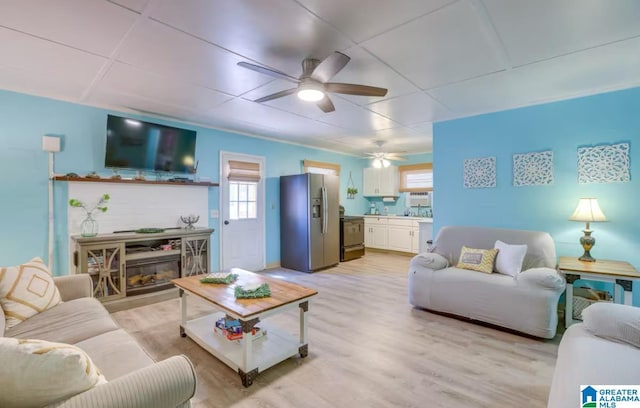 living room with ceiling fan and light hardwood / wood-style floors