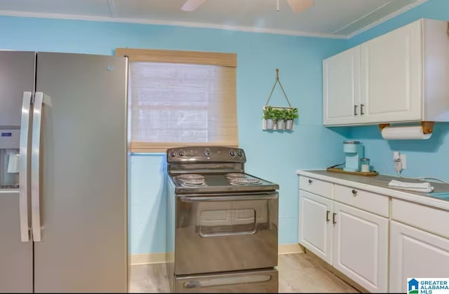 kitchen featuring white cabinets, crown molding, ceiling fan, stainless steel fridge, and range with electric stovetop