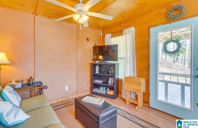 living room with ceiling fan, wooden ceiling, and light wood-type flooring