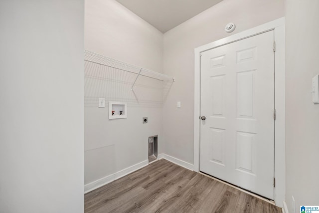 clothes washing area with electric dryer hookup, hookup for a washing machine, and wood-type flooring