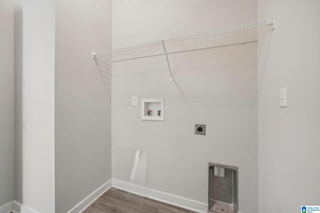 clothes washing area with hookup for an electric dryer, hookup for a washing machine, and dark wood-type flooring