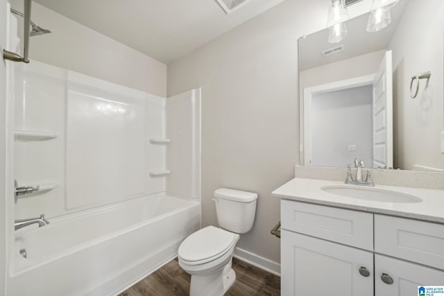 full bathroom with hardwood / wood-style floors, vanity, toilet, and shower / bath combination