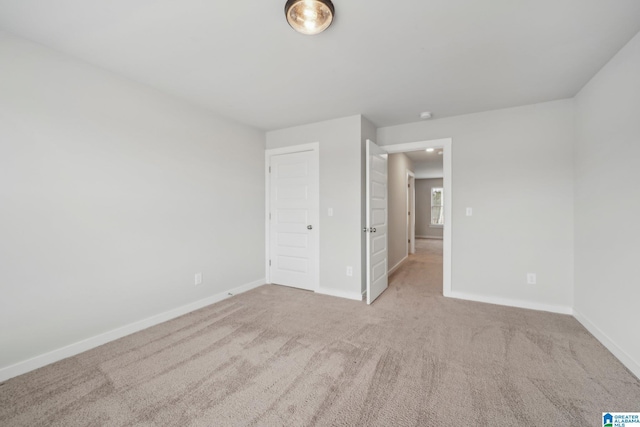 unfurnished bedroom featuring light colored carpet