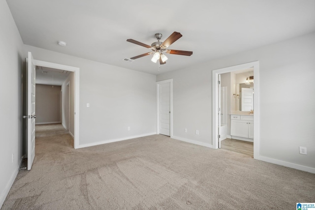 unfurnished bedroom with connected bathroom, ceiling fan, and light colored carpet