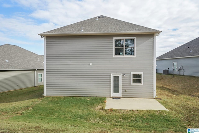 back of house featuring a yard, a patio, and central AC