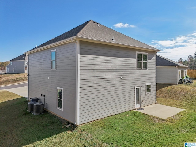 back of house with a yard, a patio area, and central air condition unit