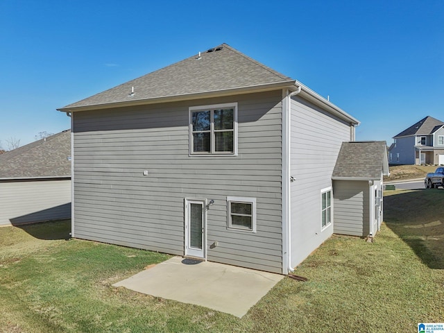 rear view of property with a patio and a lawn