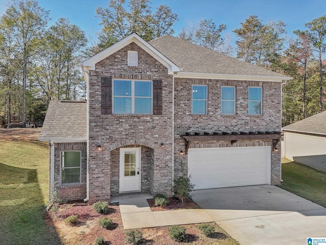 view of front of house featuring a front yard and a garage