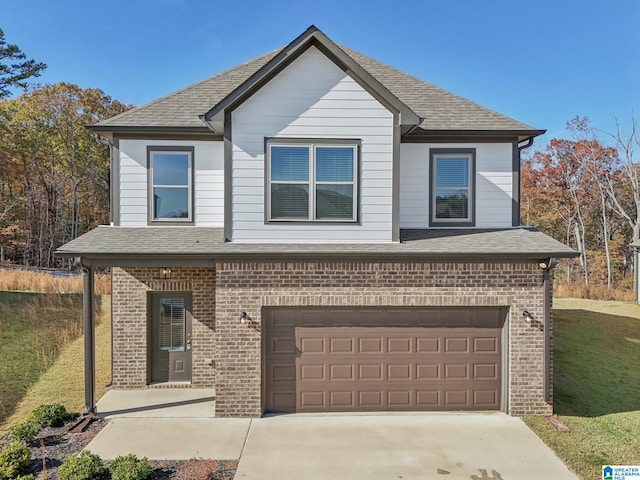 view of front of property featuring a front yard and a garage