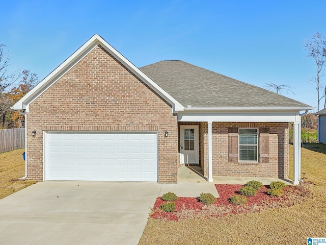 view of front of house with a front yard and a garage