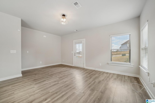 empty room with light hardwood / wood-style flooring