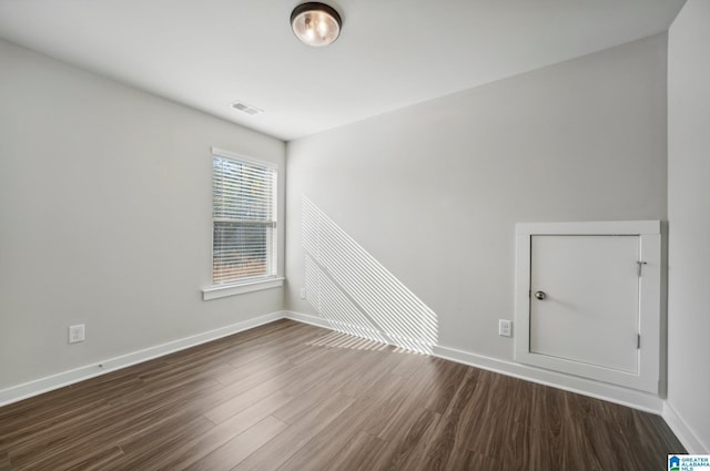 spare room with dark hardwood / wood-style flooring