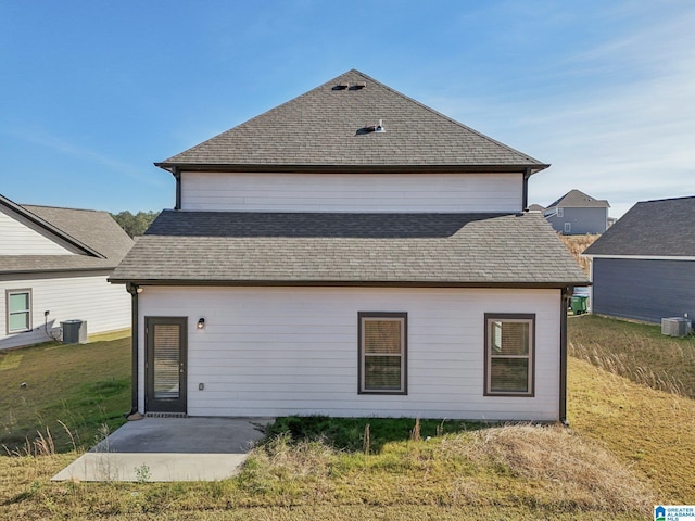 back of property with a yard, a patio, and central AC unit