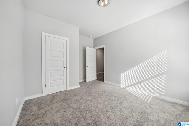 unfurnished bedroom featuring carpet and a closet