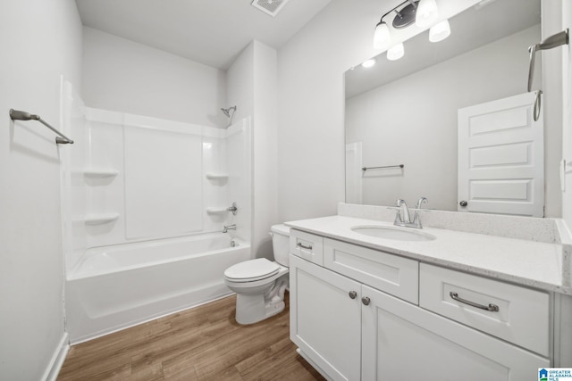 full bathroom with vanity, hardwood / wood-style flooring, toilet, and shower / washtub combination