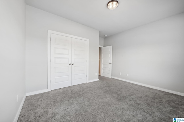 unfurnished bedroom with carpet floors and a closet