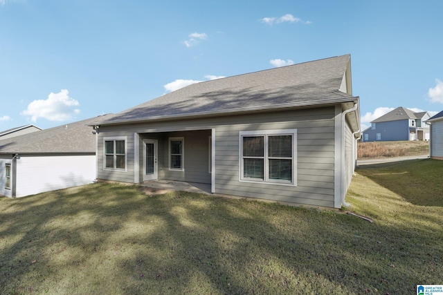 view of front of property with a patio area and a front lawn