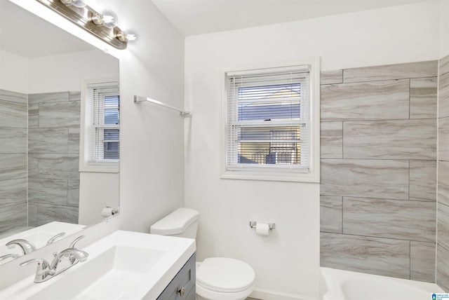 bathroom with toilet, a tile shower, and vanity