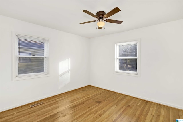 unfurnished room featuring ceiling fan and hardwood / wood-style flooring