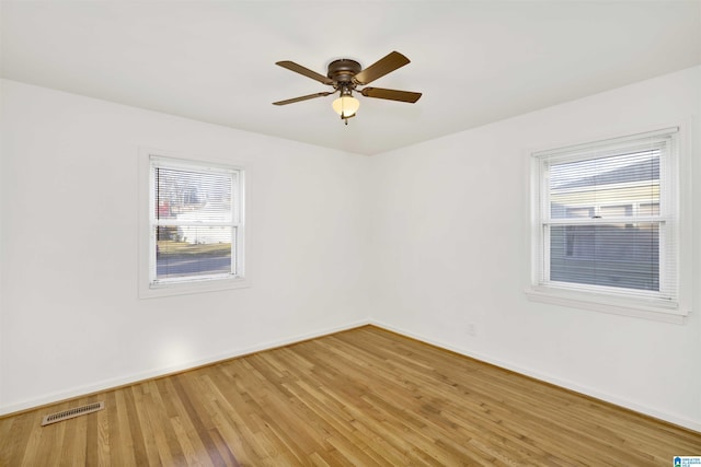 spare room featuring hardwood / wood-style floors and ceiling fan