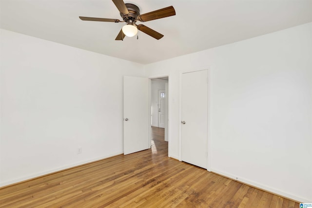 spare room with ceiling fan and hardwood / wood-style flooring