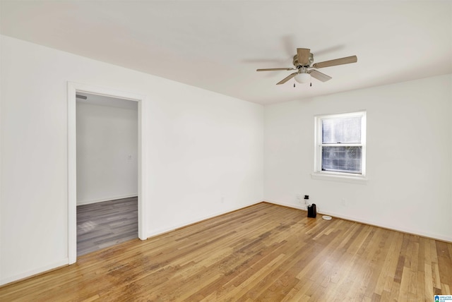 empty room featuring ceiling fan and hardwood / wood-style flooring