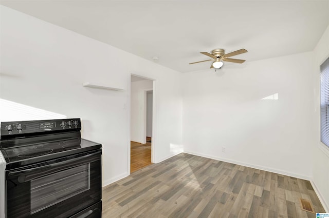 interior space featuring ceiling fan, light wood-type flooring, and black electric range oven