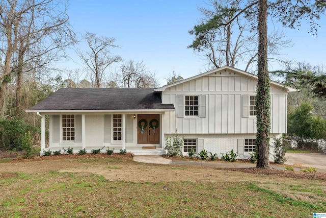 split level home featuring a front yard and covered porch